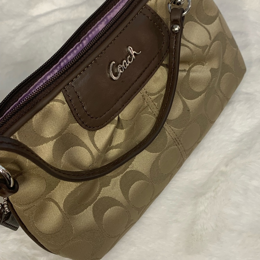 Gently pre owned Coach  “c” pattern brown wristlet wallet for women.